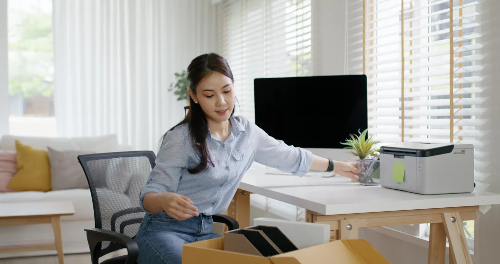 Woman organizing her work desk at home