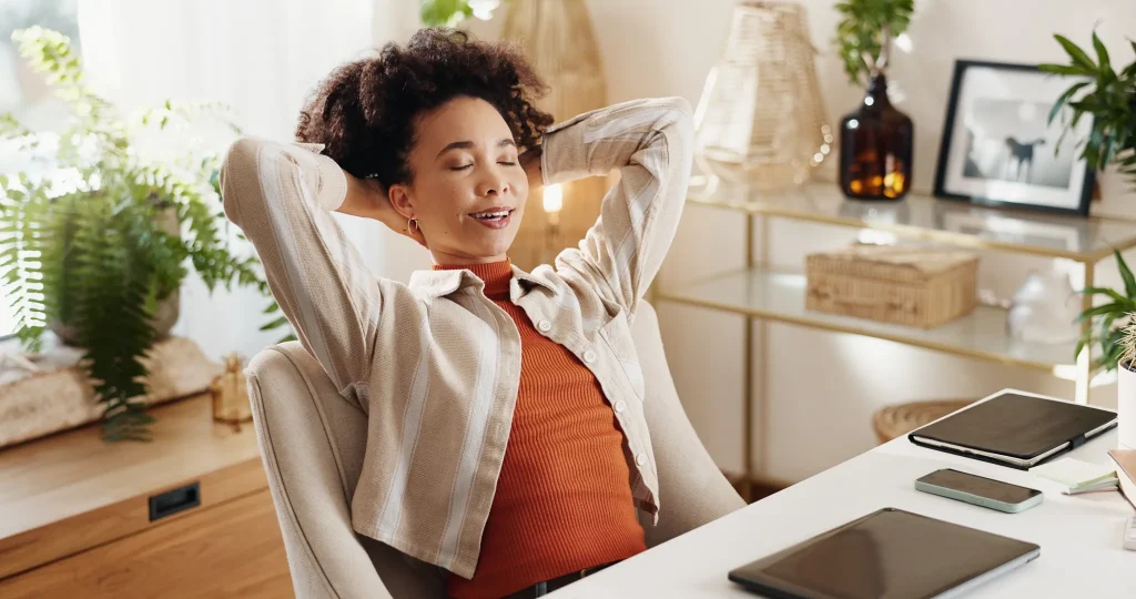 Woman relaxing at her desk in a home office