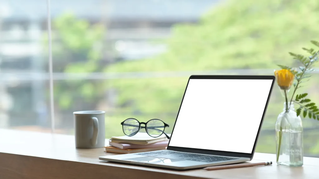 Modern home office setup with laptop and coffee cup