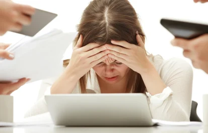 Stressed woman overwhelmed by multiple tasks at work